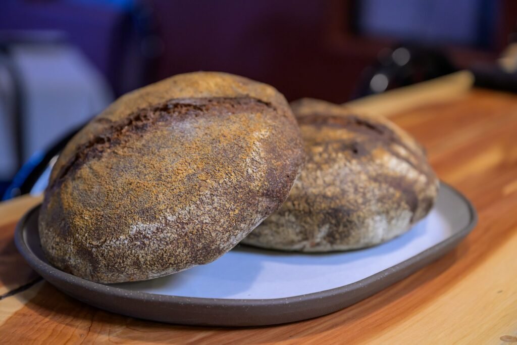 Two round sourdough loaves on a board